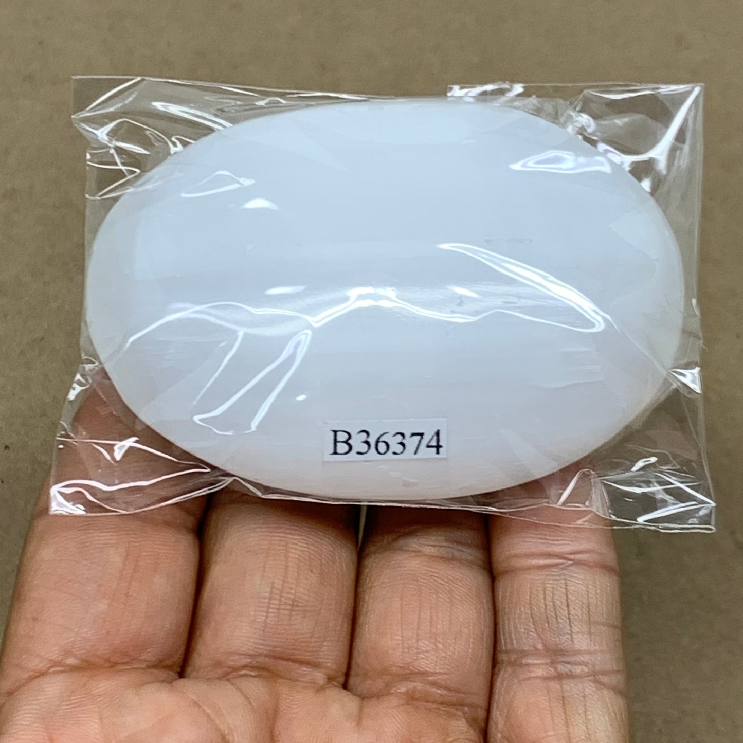 97g, 2.8"x2"x0.9", White Selenite Palmstone Crystal Pillow Reiki, B36374
