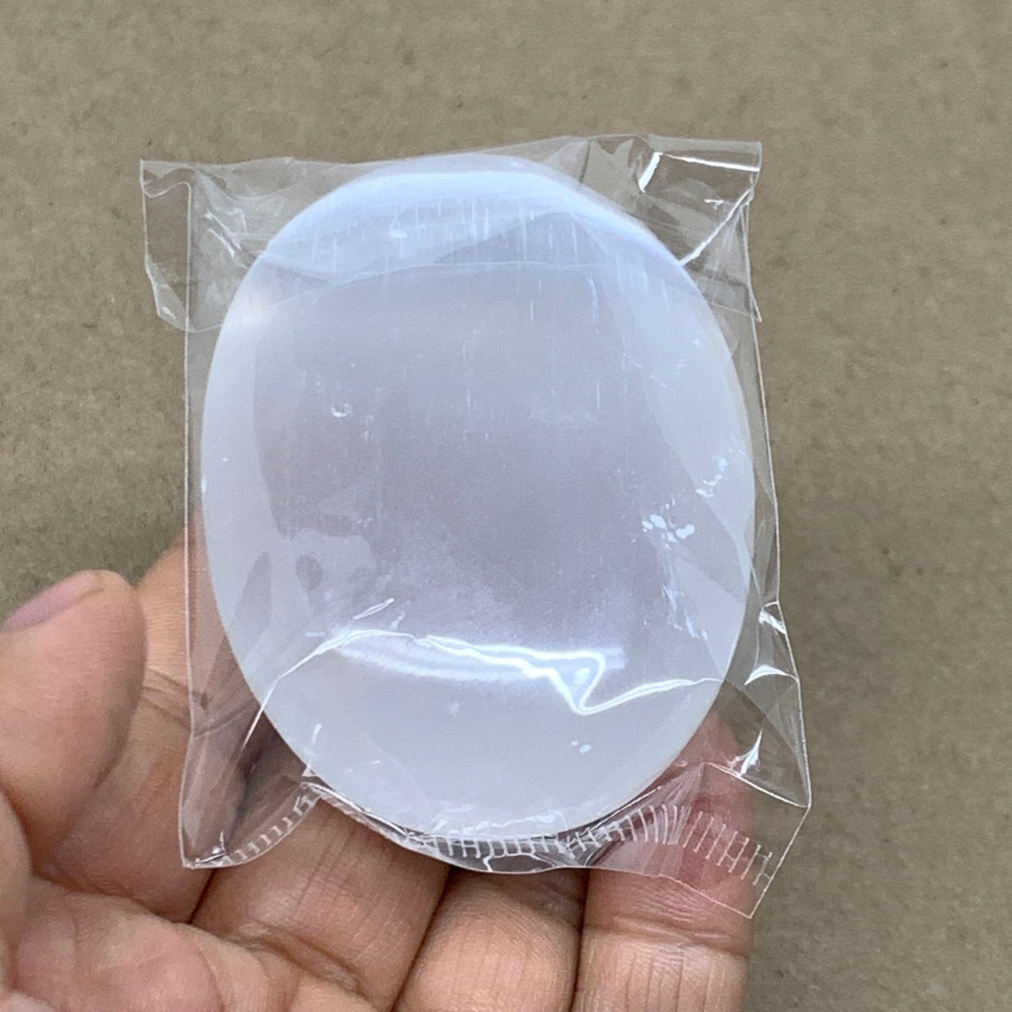 94g, 2.7"x2"x0.9", White Selenite Palmstone Crystal Pillow Reiki, B36383