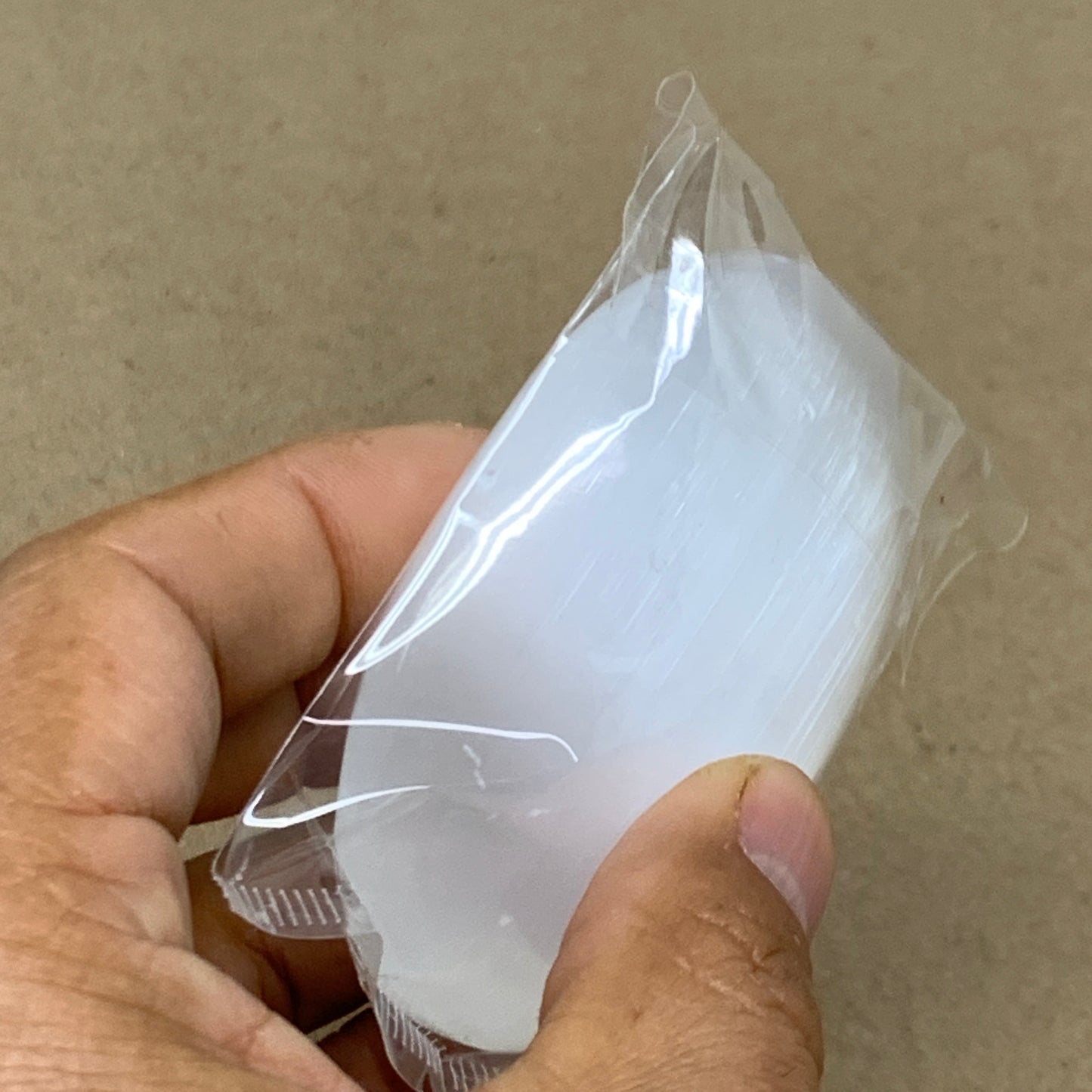 94g, 2.7"x2"x0.9", White Selenite Palmstone Crystal Pillow Reiki, B36383