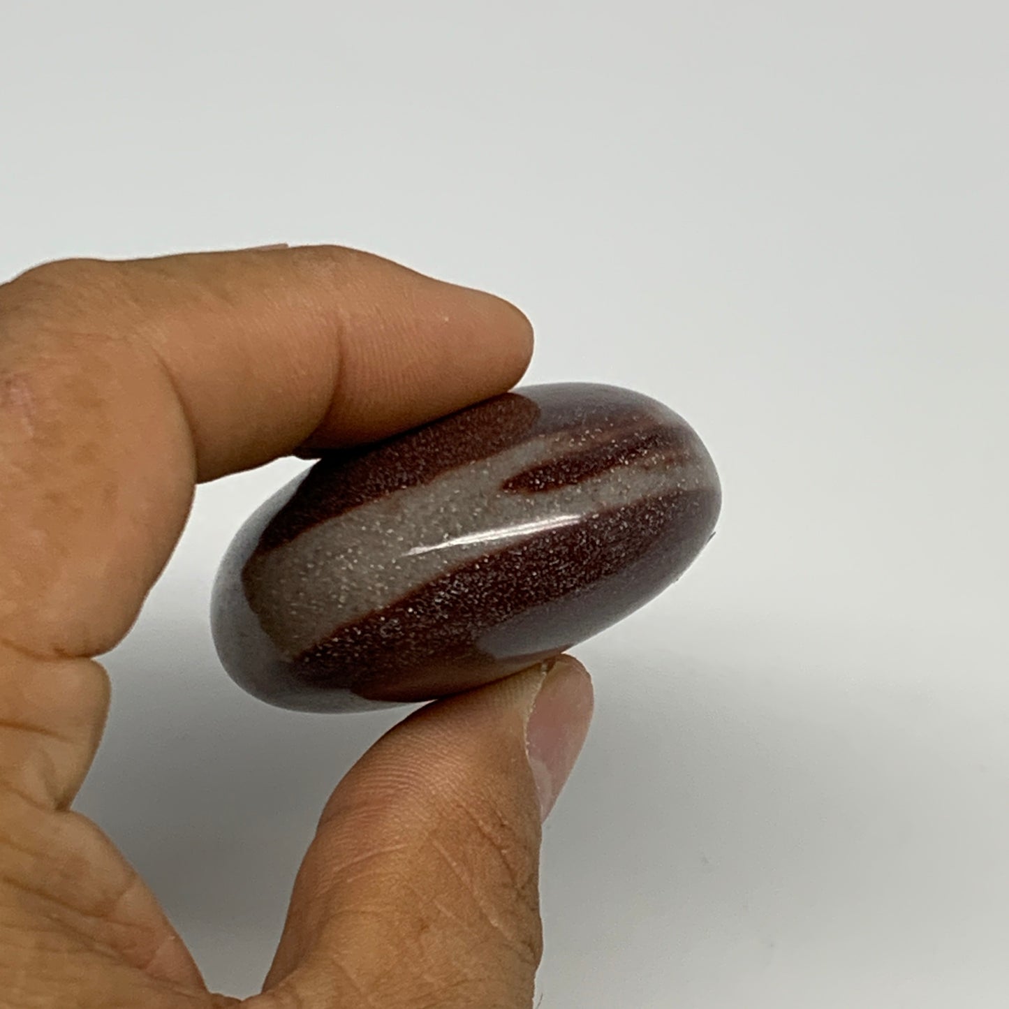 91.2g, 2.3"x1.7"x0.9", Narmada Shiva Lingam Palm-Stone Polished, B29380