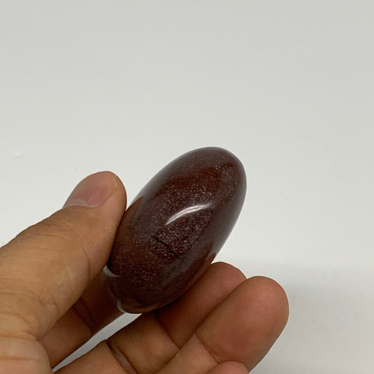 95.8g, 2.3"x1.7"x0.9", Narmada Shiva Lingam Palm-Stone Polished, B29383