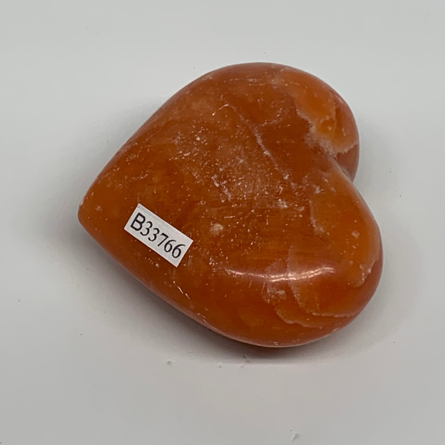125.2g, 2.2"x2.6"x1.1" Orange Calcite Heart Gemstones from Madagascar, B33766