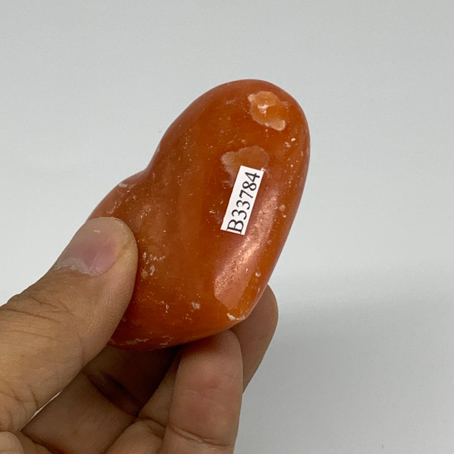 109.9g, 2.2"x2.6"x1" Orange Calcite Heart Gemstones from Madagascar, B33784